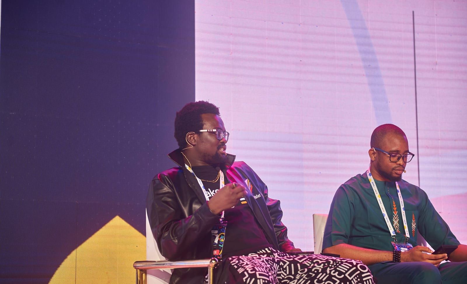 David seated on the Clarity in Compliance panel with a mic, turned toward a co-panellist.