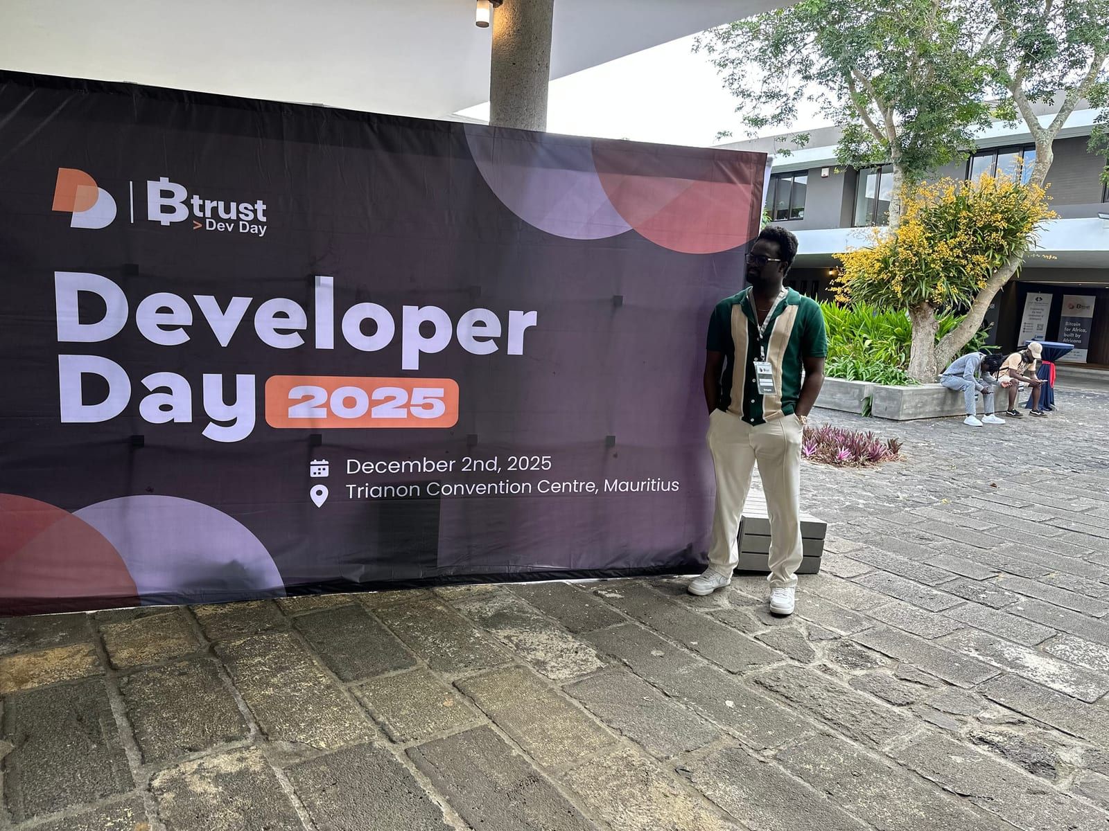 David beside the Btrust Developer Day 2025 banner at the Trianon Convention Centre in Mauritius.